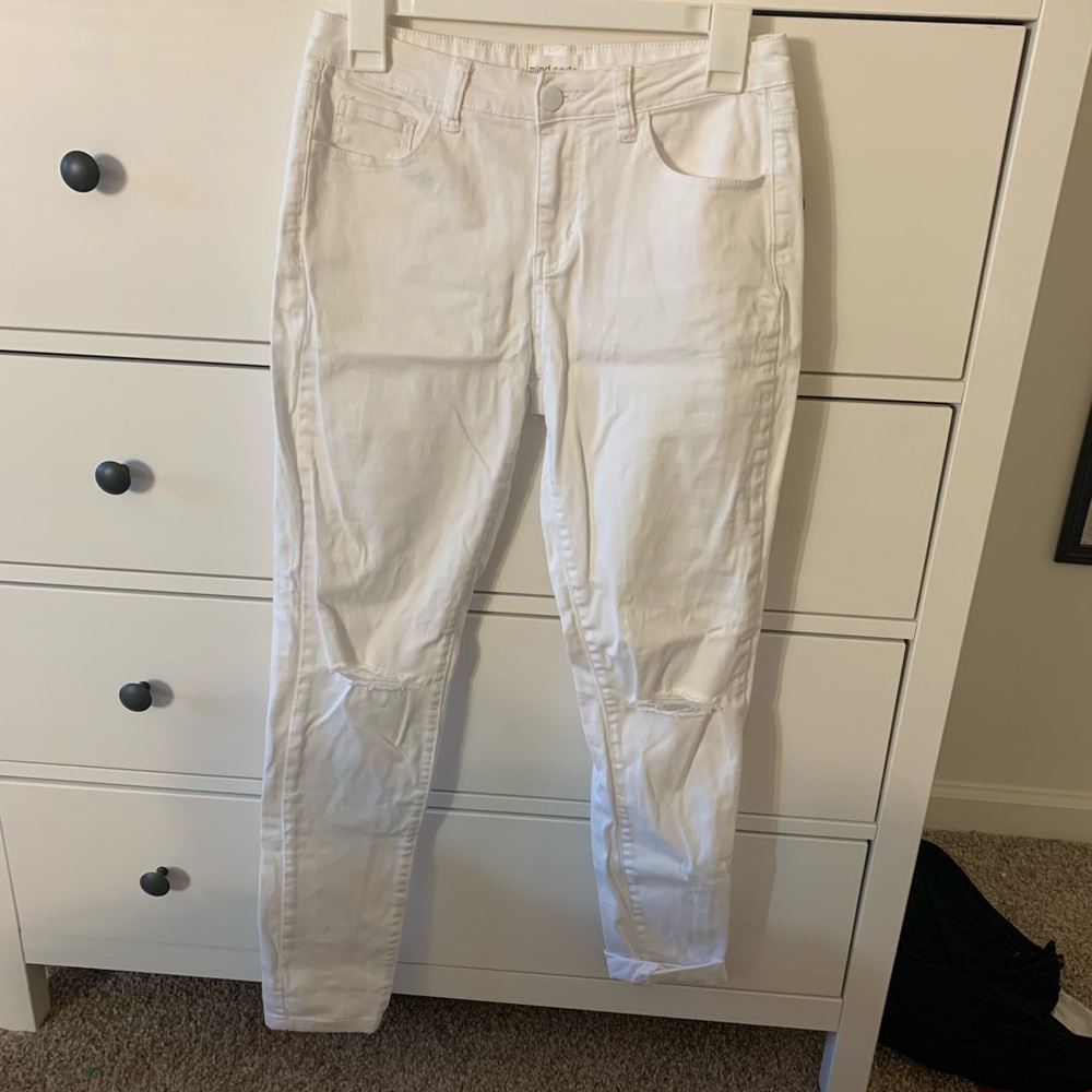 Distressed white skinny jeans